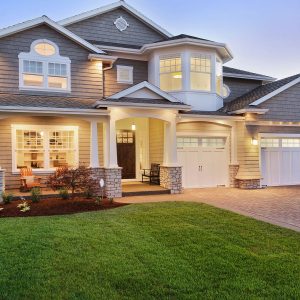 56095762 - luxury home exterior with green grass and driveway at sunset